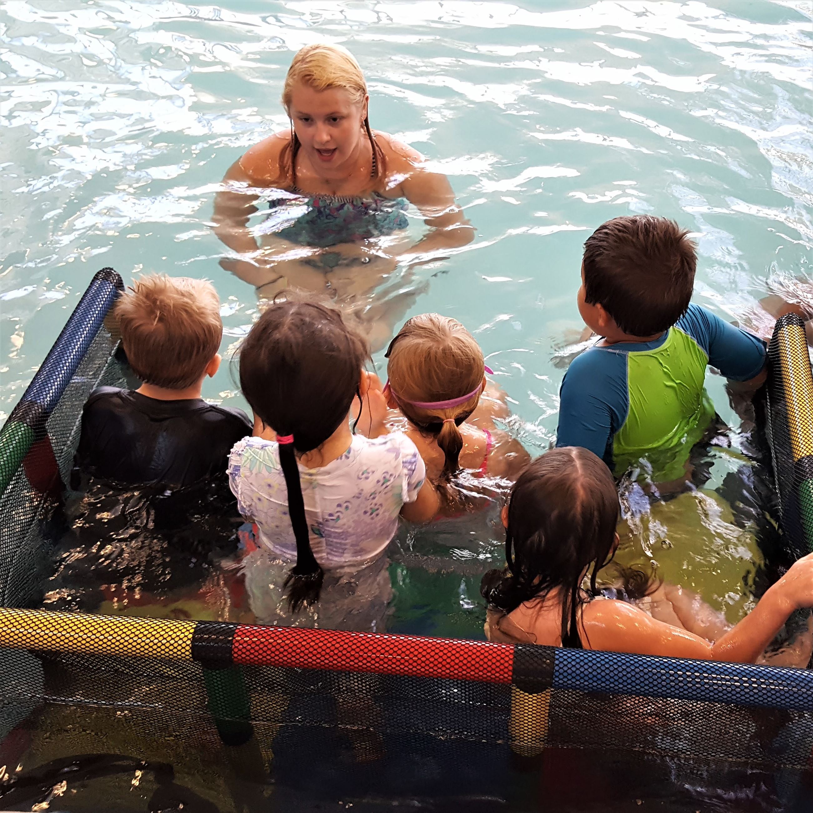 Instructor and children during a swimming lesson