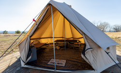 Front view of a large, tan canvas tent known as a bell tent