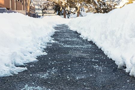 Salt on Snowy Sidewalk